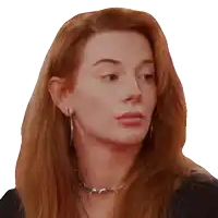 a woman with red hair is wearing hoop earrings