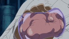 a close up of a person 's fist with a purple glove on