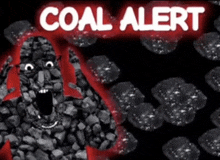 a sign that says coal alert is surrounded by black rocks