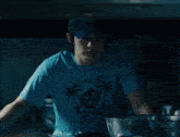 a man wearing a blue shirt that says pacific on it