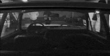 a man in a hat is sitting in a car