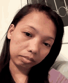 a close up of a woman 's face with a serious look on her face