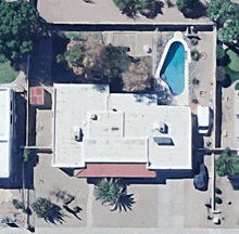 an aerial view of a house with a pool