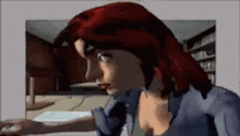 a woman with red hair is sitting at a table using a computer .