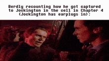 two men are standing next to each other in a dark room talking to each other .