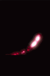 two women are standing next to each other and their faces are glowing pink