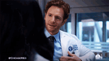 putting on my lab coat dr will halstead chicago med getting ready grin