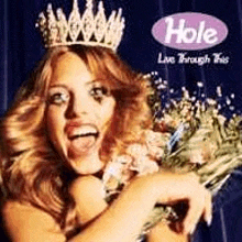 a woman in a crown is holding a bouquet of flowers .