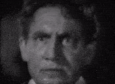 a close up of a man 's face with a tear running down his eye