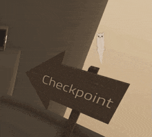 a wooden arrow pointing to the checkpoint with a cat on top of it