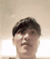 a blurry picture of a man 's face looking up at the camera .