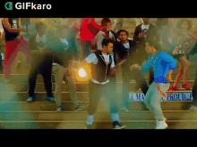 a group of people are dancing in front of a sign that says ' proud ' on it