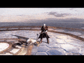 a man in a red coat is standing next to a man on the ground in a video game