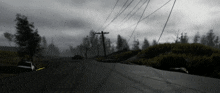 a black and white photo of a road with telephone poles