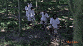 a group of men are riding bicycles in the woods with the words man laksa on the bottom right