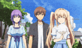 a boy and two girls are standing next to each other with one girl holding cotton candy