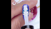 a person is applying nail polish to their nails with a bottle .