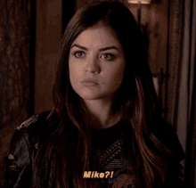 a close up of a woman 's face with mike written on the bottom