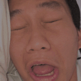 a man is making a funny face with his tongue out