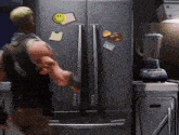 a man is standing in front of a refrigerator with a smiley face magnet on it