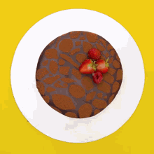 a chocolate cake with strawberries on top of it