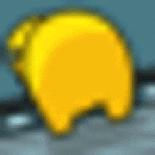 a blurred image of a yellow cartoon character standing on a table .
