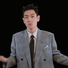 a man wearing a suit and tie is making a funny face