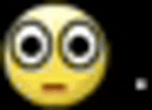 a close up of a yellow smiley face with a black background .