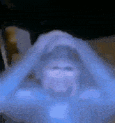a blurred image of a person 's face with their hands on their face