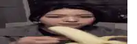 a woman is eating a banana with her mouth