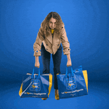 a woman is holding two shopping bags that say uno spin on them