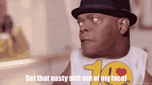 a man is wearing a hat and a shirt that says get that nasty shit out of my face