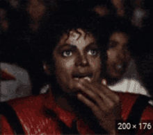 a man with a surprised look on his face is sitting in a crowd with a 200 x 176 watermark