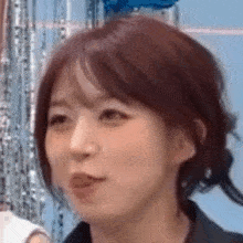 a close up of a woman 's face with her mouth open .
