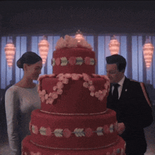 a bride and groom are cutting a red wedding cake