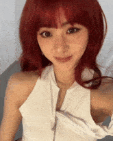 a woman with red hair is wearing a white halter top