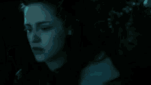 a close up of a person 's face in a dark room in a blurry photo .