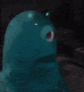 a close up of a blue monster with a red eye .