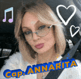 a woman wearing glasses is sitting in a car with the name cap annarita written in blue