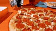 a pizza with pepperoni and sausage on it