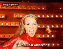 britney spears is wearing a red outfit and screaming .