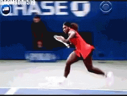 GIF of tennis great, Serena Williams sliding into a split which trying to swing at a ball.