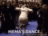a woman is dancing in front of a crowd with the words `` mema 's dance '' written above her .