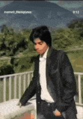 a man in a suit and white shirt is walking on a balcony with a watermark that says meme_0templates