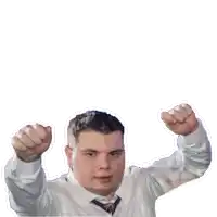 a man in a white shirt and tie holds his fists up in the air