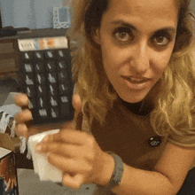 a woman is holding a calculator that says ' xerox ' on the top