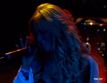 a woman singing into a microphone with the words rbd.gif in the lower right corner