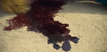 a person laying on the ground with blood on the ground .