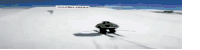 a person skiing down a snow covered hill with a sign that says auburn