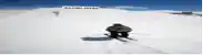 a person skiing down a snow covered hill with a sign that says auburn